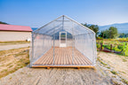 Sprout greenhouse with poly film roof and plank deck, door open