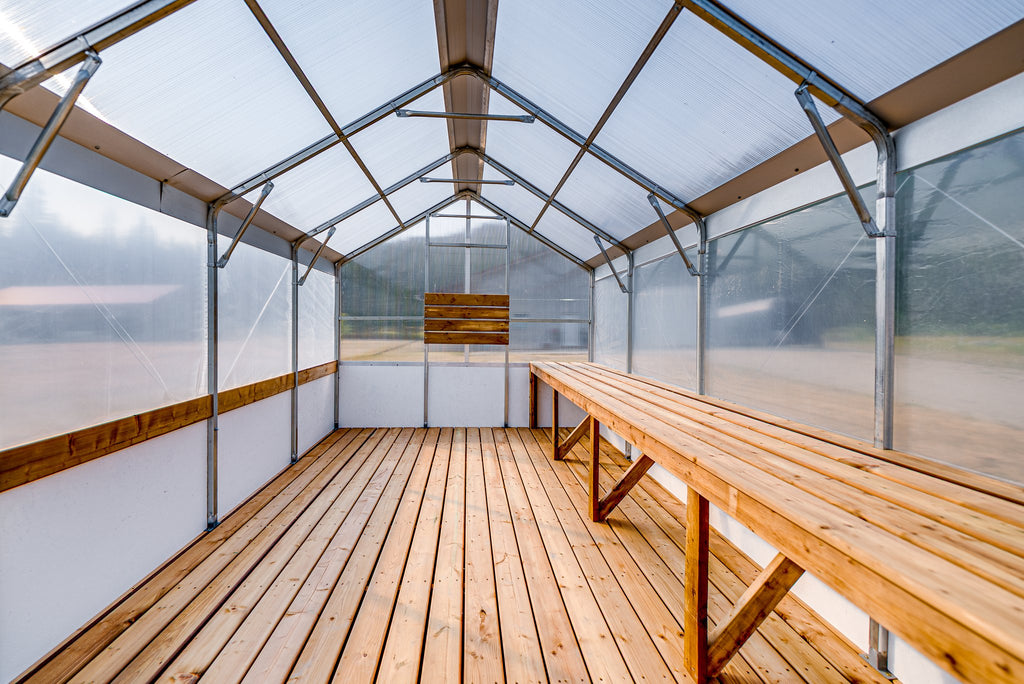Full-length heavy-duty work bench running the length of the Harvest greenhouse